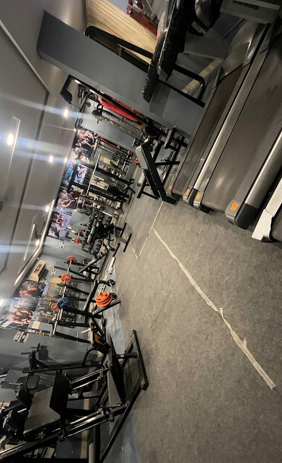 Gym floor with treadmills, benches and strength machines